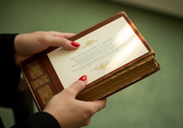 Hands holding a beautiful, personalized photo invitation